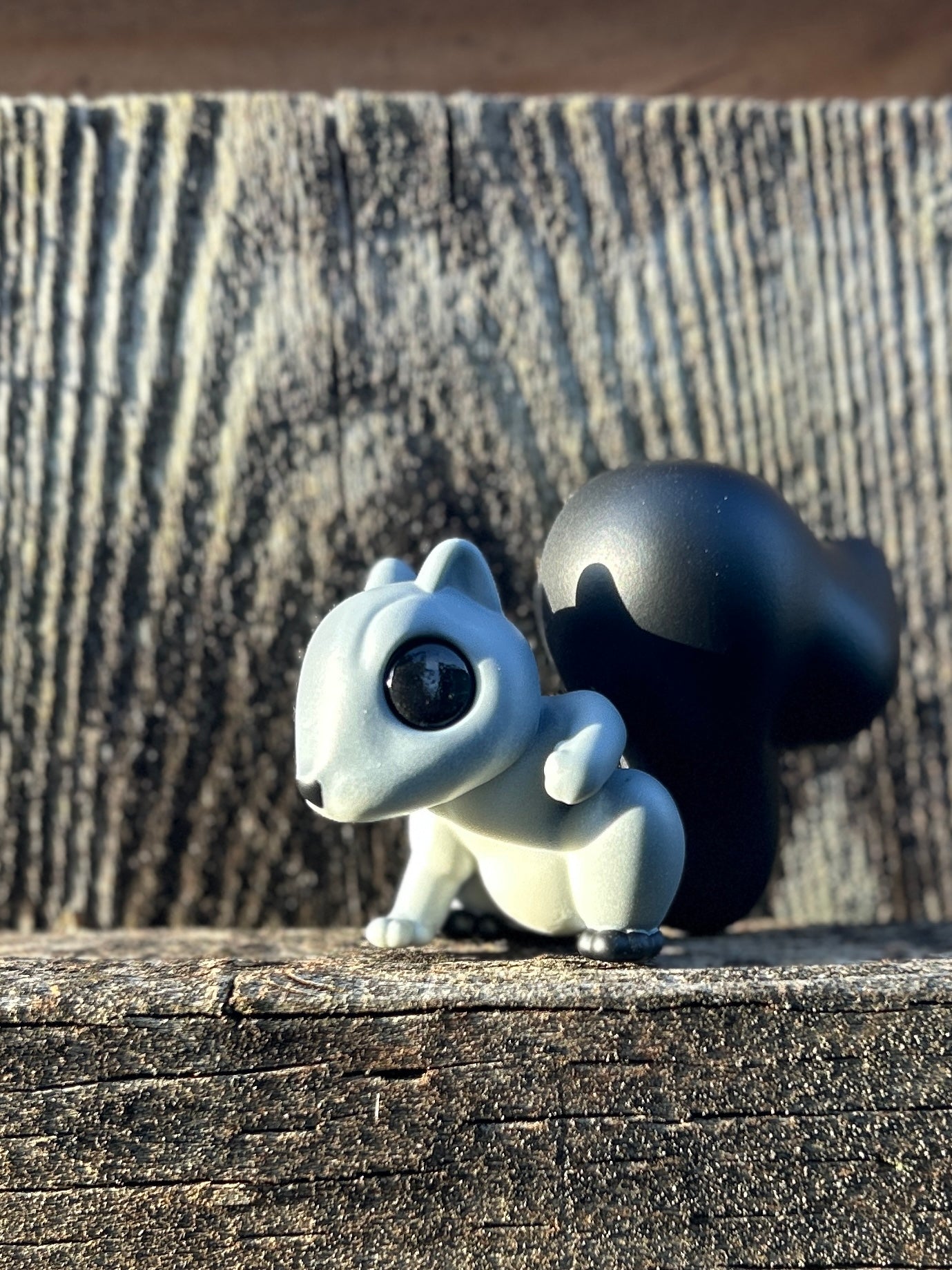 Grey squirrel with black tail and feet figure