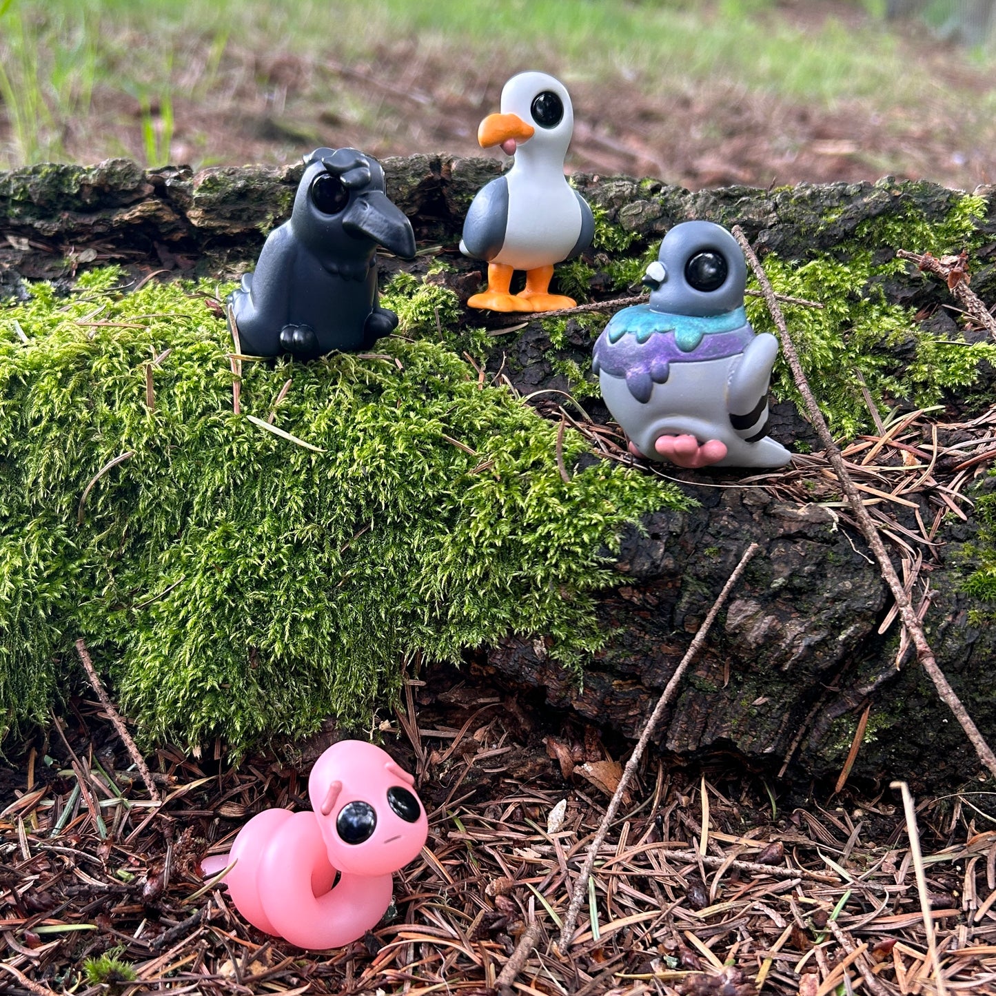 Crow, seagull, pigeon, and worm figurines
