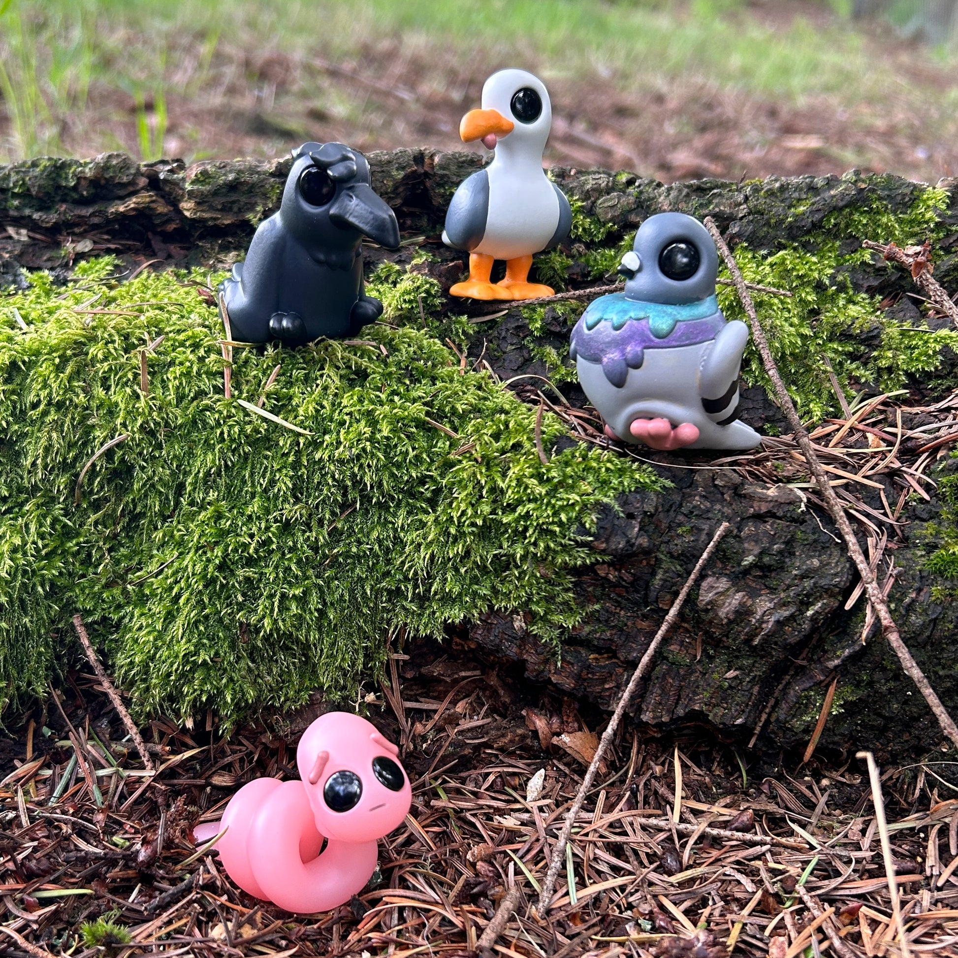 Crow, seagull, pigeon, and worm figurines