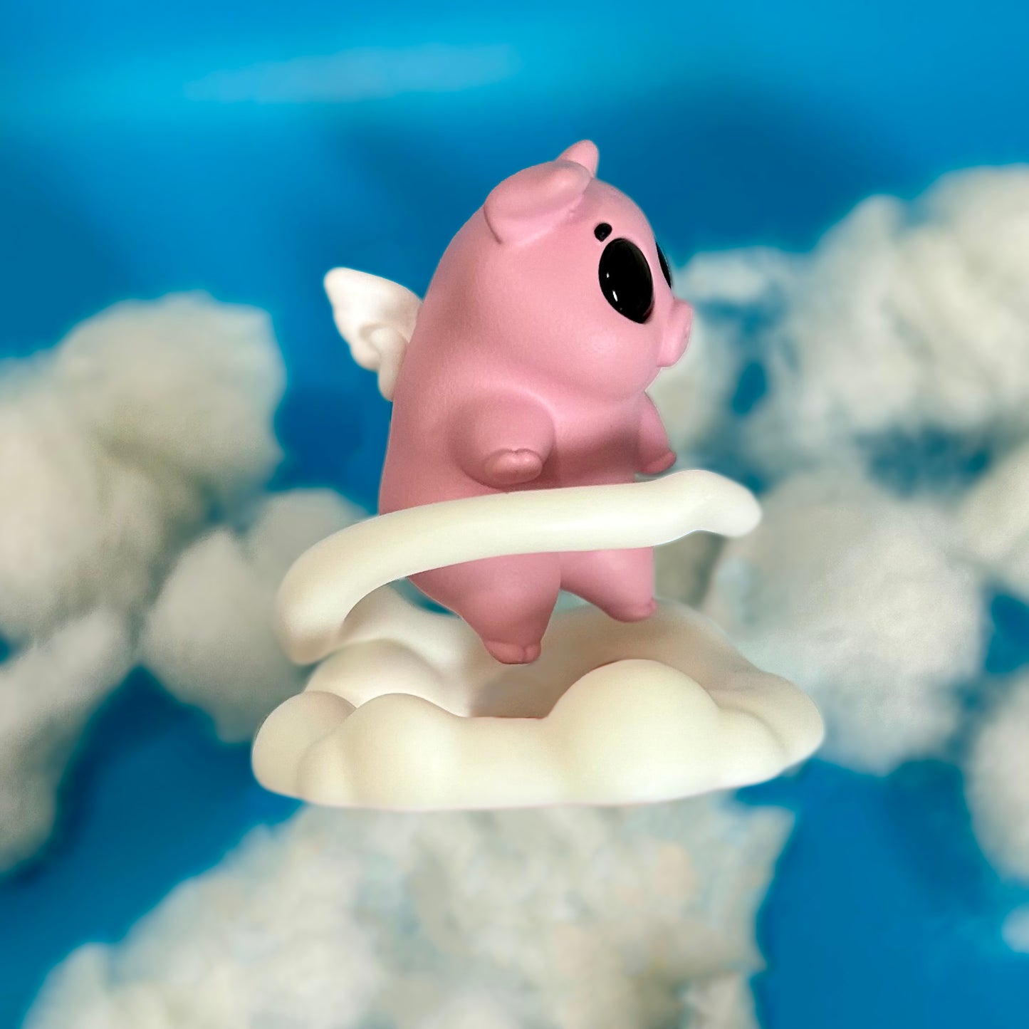 Flying pig figure on cloud stand - side