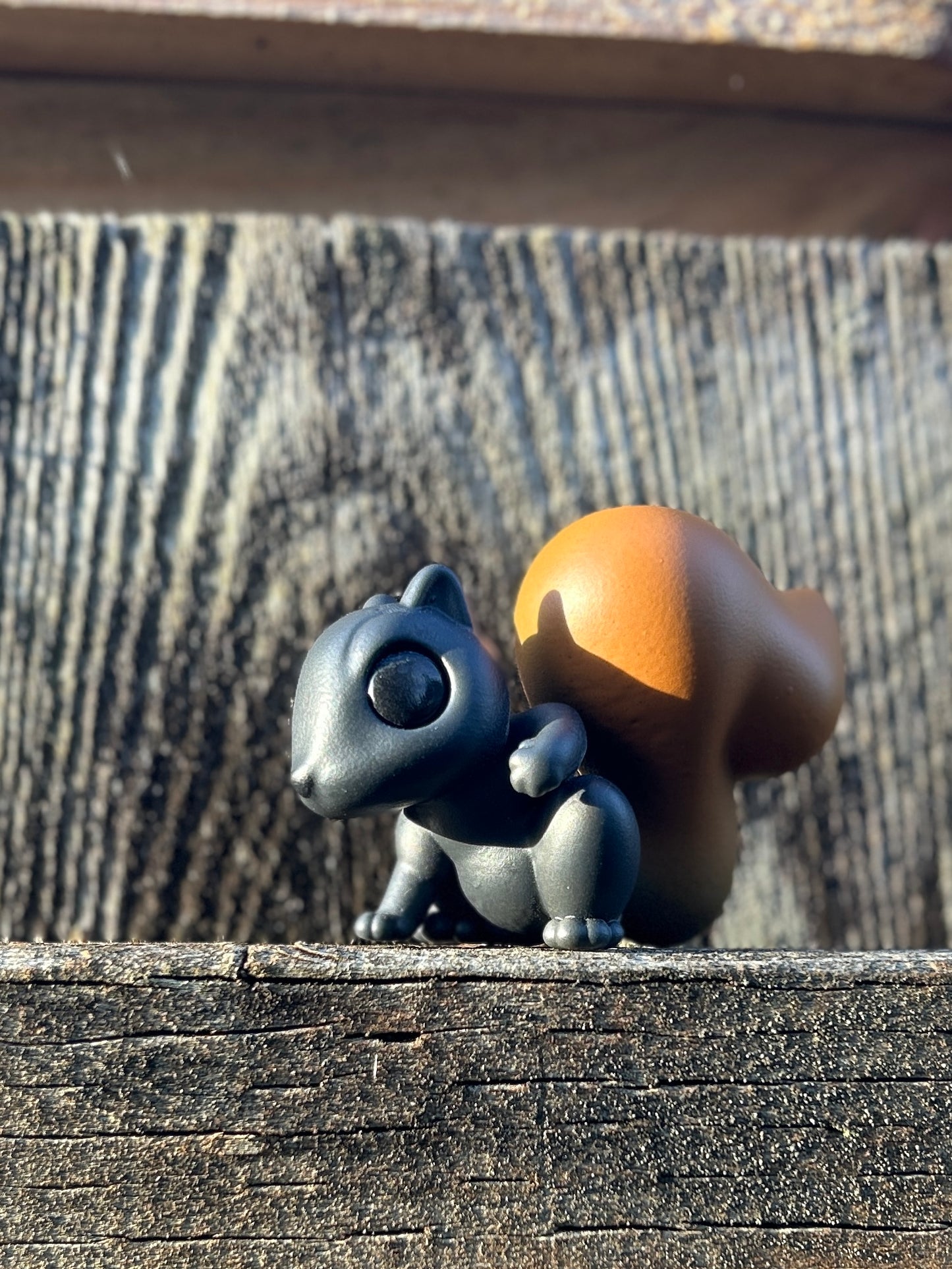 Black squirrel with red tail figure