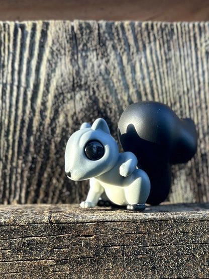 Grey squirrel with black tail and feet figure