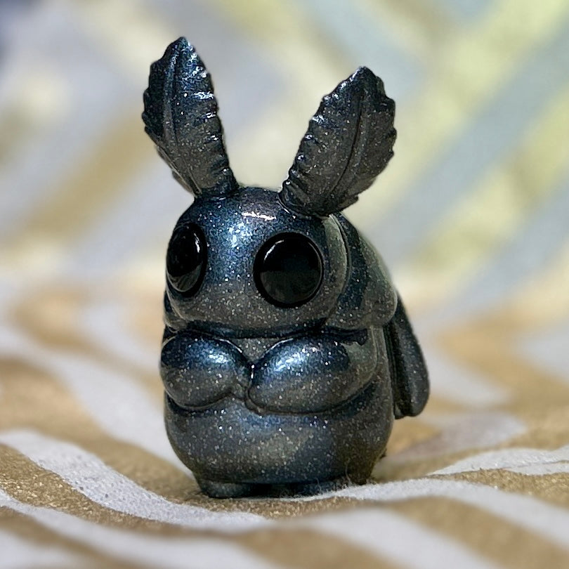 Sparkly moth man figurine