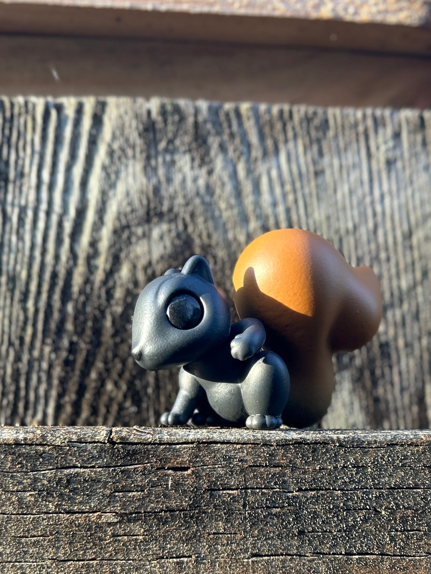 Black squirrel with red tail figure